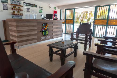 a waiting room with chairs and a table in a store at Colina del Sol Hotel Hacienda in Quimbaya