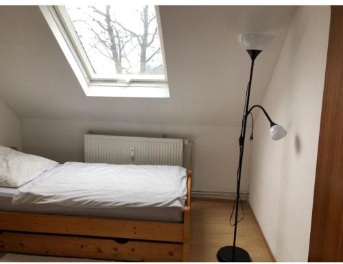 a bedroom with a bed with a lamp and a window at Siegen Zentral - S von eine bis zum mehrere Schlafplätze nach Wall in Siegen