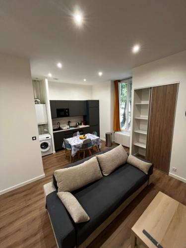 un salon avec un canapé et une table dans l'établissement Le Grand HELDER, à Vichy