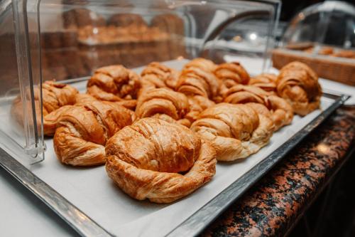 a bunch of croissants on a tray in a bakery at hotel plaza BRISAS MT in Punta Cana
