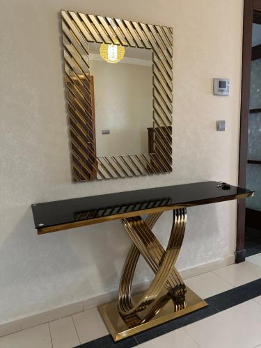 a dressing table with a mirror on a wall at Mobilart tour A etage 2 in Courbet