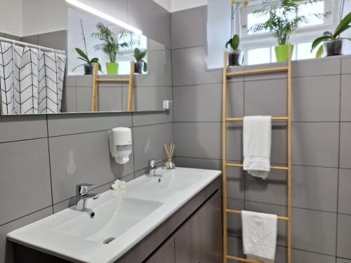 a bathroom with a sink and a mirror at Casa da Furna in Santo António