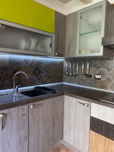 a kitchen with wooden cabinets and a sink at Il Borghetto in Pesaro