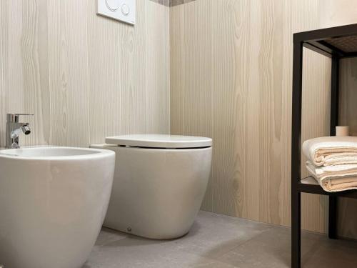 a bathroom with a white toilet and a sink at Non ti scordar di me #2 in Pieris