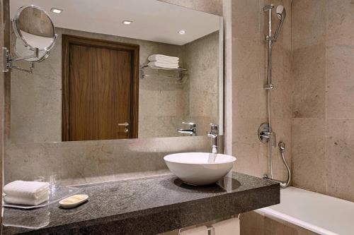 a bathroom with a sink and a mirror at Sheraton Tunis Hotel in Tunis