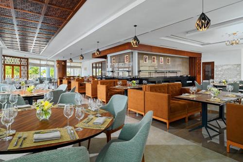 a restaurant with tables and chairs and a bar at Sheraton Tunis Hotel in Tunis