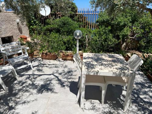 a table and two chairs and a table and a lamp at Suite Panoramic in Porticello