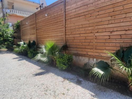 a wooden fence with plants in front of it at Amare suite in Perivólia