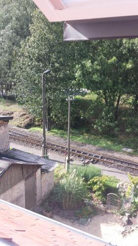 a train station with a view of a train track at Holzwerk Oybin in Kurort Oybin