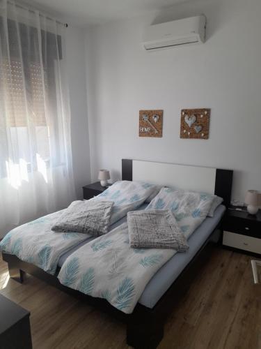 uma cama com duas almofadas num quarto em Apartman Envi em Opatija