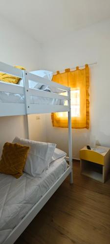 a bedroom with a bunk bed and a window at Profumo di casa in Lascari