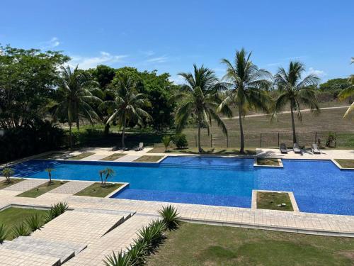 an image of a swimming pool with palm trees at Playa Blanca Beach Rentals in Playa Blanca