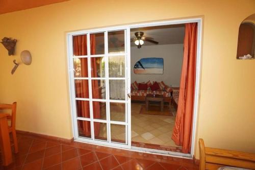 a room with a sliding glass door to a living room at Villa Playa Bonita, Pool, Tropical Gardens in Las Terrenas