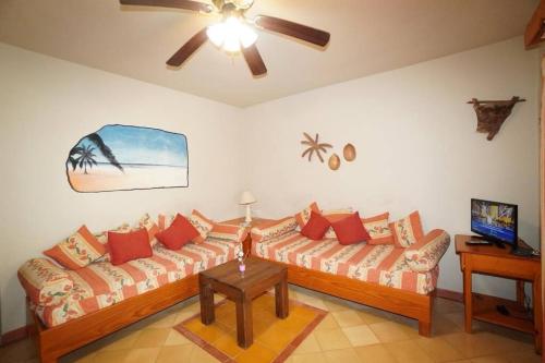 a living room with two couches and a ceiling fan at Villa Playa Bonita, Pool, Tropical Gardens in Las Terrenas