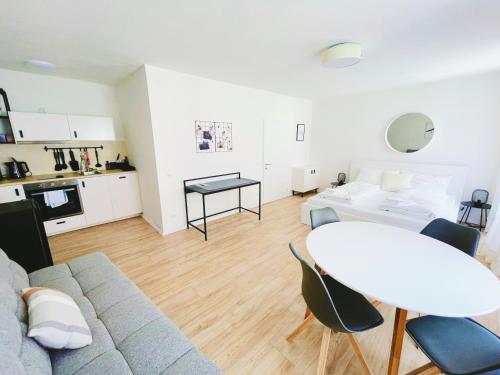 a living room with a couch and a table at StayHere Central City Studio 12 - contactless Self-Check-IN in Graz