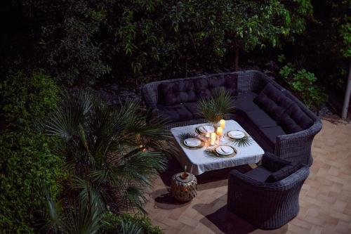 a black couch with a table with candles on it at GREEN HILL Aparts with POOL & SCENIC VIEW in Gornji Orahovac