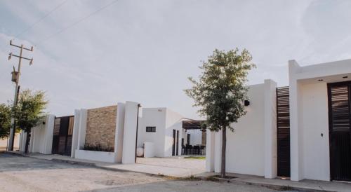 a row of white buildings on a street at Casa Villa Sol in Cuatrociénegas de Carranza