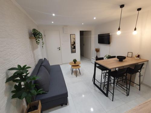 a living room with a blue couch and a table at Vacation Liberation Apartment in Split