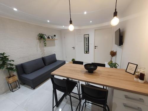 a living room with a blue couch and a table at Vacation Liberation Apartment in Split
