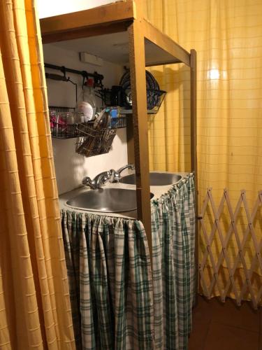 a sink in a bathroom with a shower curtain at Chalés na Montanha - casa do lado - Serra da Estrela in Manteigas