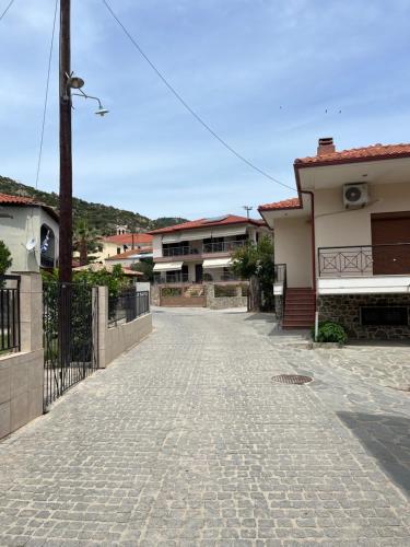 a cobblestone street in front of some houses at Ck apartment in Sikia