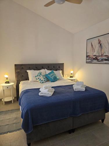 a bedroom with a large bed with towels on it at Vila Brod in Šibenik