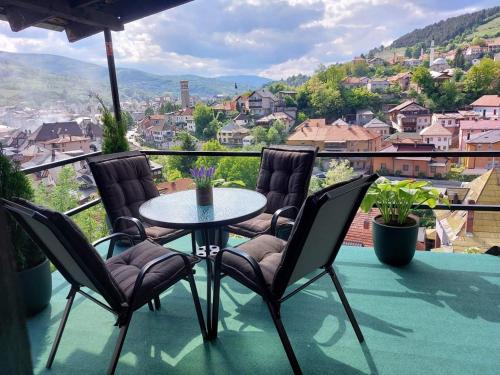 a table and chairs on a balcony with a view at Panorama Travnik in Travnik