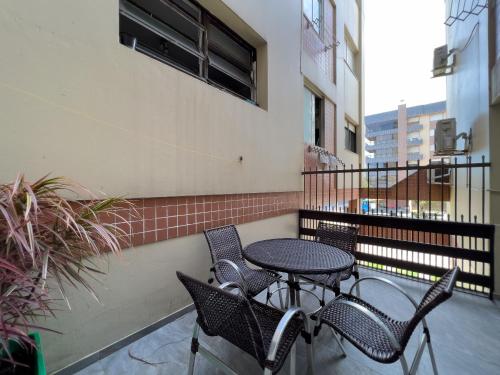 a patio with a table and chairs on a balcony at Vista espetacular beira mar - Capão da Canoa in Capão da Canoa