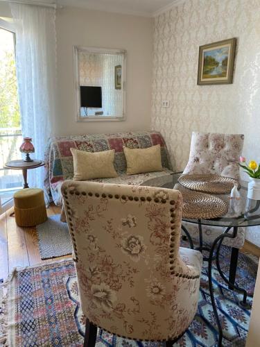 a living room with a couch and a table at Guest House Wiejska Sielanka in Brody