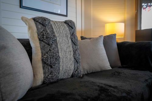 a pile of pillows on a couch in a living room at Blissful Birchs Bay - Gorgeous 3 Bedroom House in Woodbridge