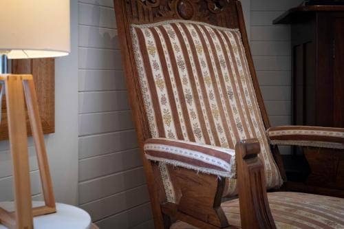 a rocking chair in a room with a lamp at Blissful Birchs Bay - Gorgeous 3 Bedroom House in Woodbridge