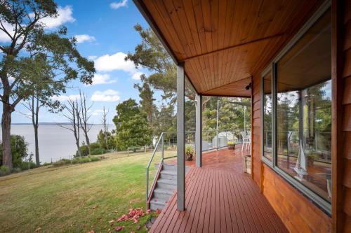a porch of a house with a view of the water at Blissful Birchs Bay - Gorgeous 3 Bedroom House in Woodbridge