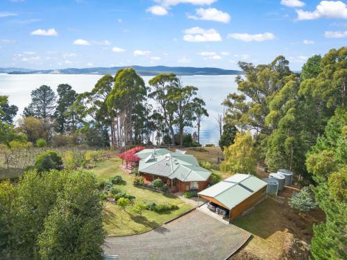 an aerial view of a house with a lake in the background at Blissful Birchs Bay - Gorgeous 3 Bedroom House in Woodbridge
