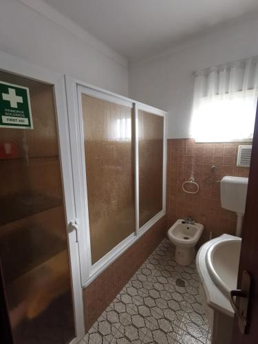 a bathroom with a shower and a toilet and a sink at Moradia Coelho in Lousã