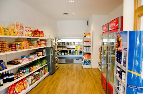 a grocery store aisle with lots of products at Dormio Hotel Obertraun in Obertraun