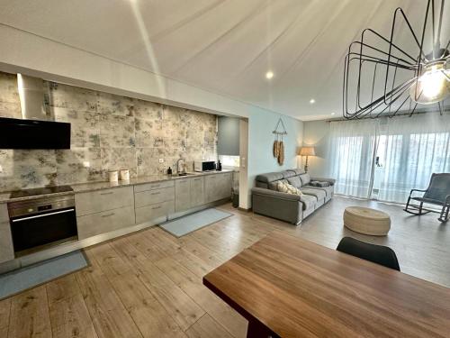 a large living room with a couch and a table at Beach Retreat in Torres Vedras