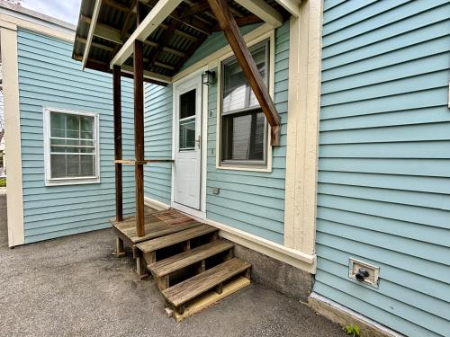 a porch of a blue house with a wooden staircase at Traveler’s Den in Medford in Medford