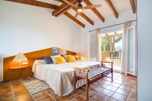 a bedroom with a bed and a table and a chair at Terra Nura in Son Xoriguer