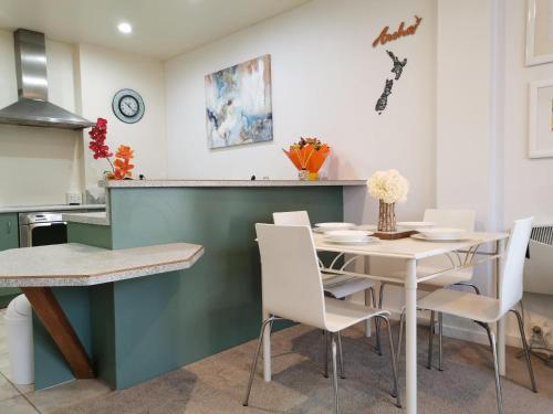 a kitchen and dining room with a table and chairs at Wellington Central, 2bedroom Suite in Wellington