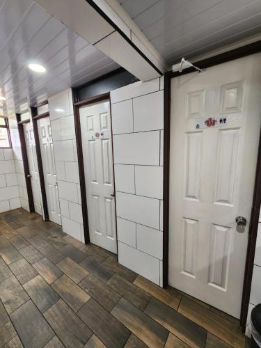 a room with white doors and a tile floor at Costa Rica Backpackers in San José
