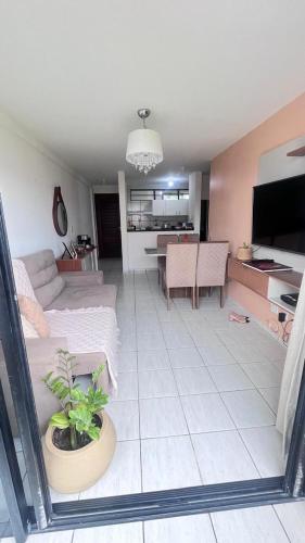 a living room with a bed and a dining room at AP 104 Flat Portinari in São Luís