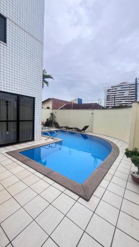 a swimming pool on the side of a building at AP 104 Flat Portinari in São Luís