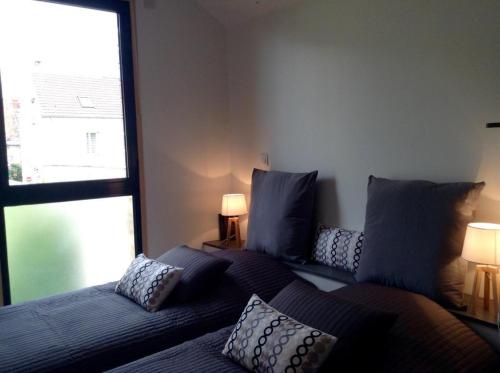 a living room with a couch and a window at Les Co Gîte in Vigny