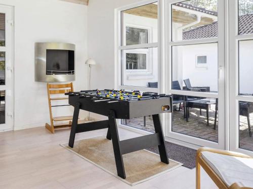 a ping pong table in a living room with a tv at 8 person holiday home in Højslev-By Traum in Højslev