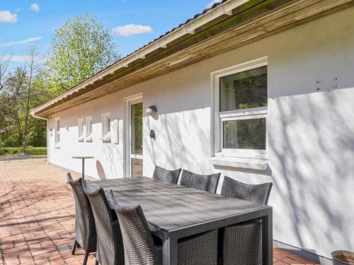 a wooden table and chairs on a patio at 8 person holiday home in Højslev-By Traum in Højslev