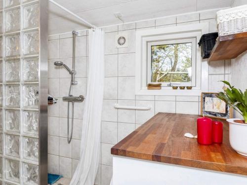 a bathroom with a shower and a wooden counter at Holiday home Farsø IX in Farsø