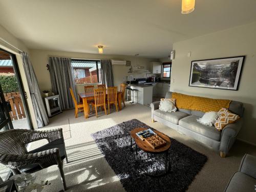 a living room with a couch and a table at 11 Dorset Street in Hanmer Springs