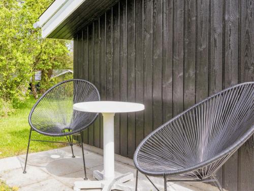 two chairs and a table on a patio at 6 person holiday home in Farsø-By Traum in Farsø