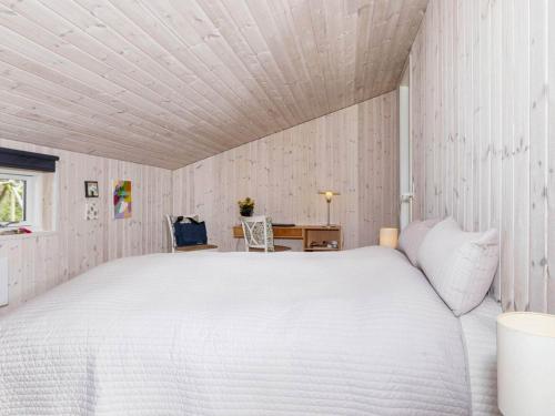 a bedroom with a white bed and a desk at Holiday home Farsø IX in Farsø