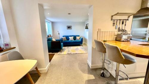 a kitchen and living room with a table and chairs at The West Wing in Devizes